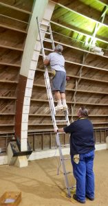 Jeff climbs ladder in the hangar